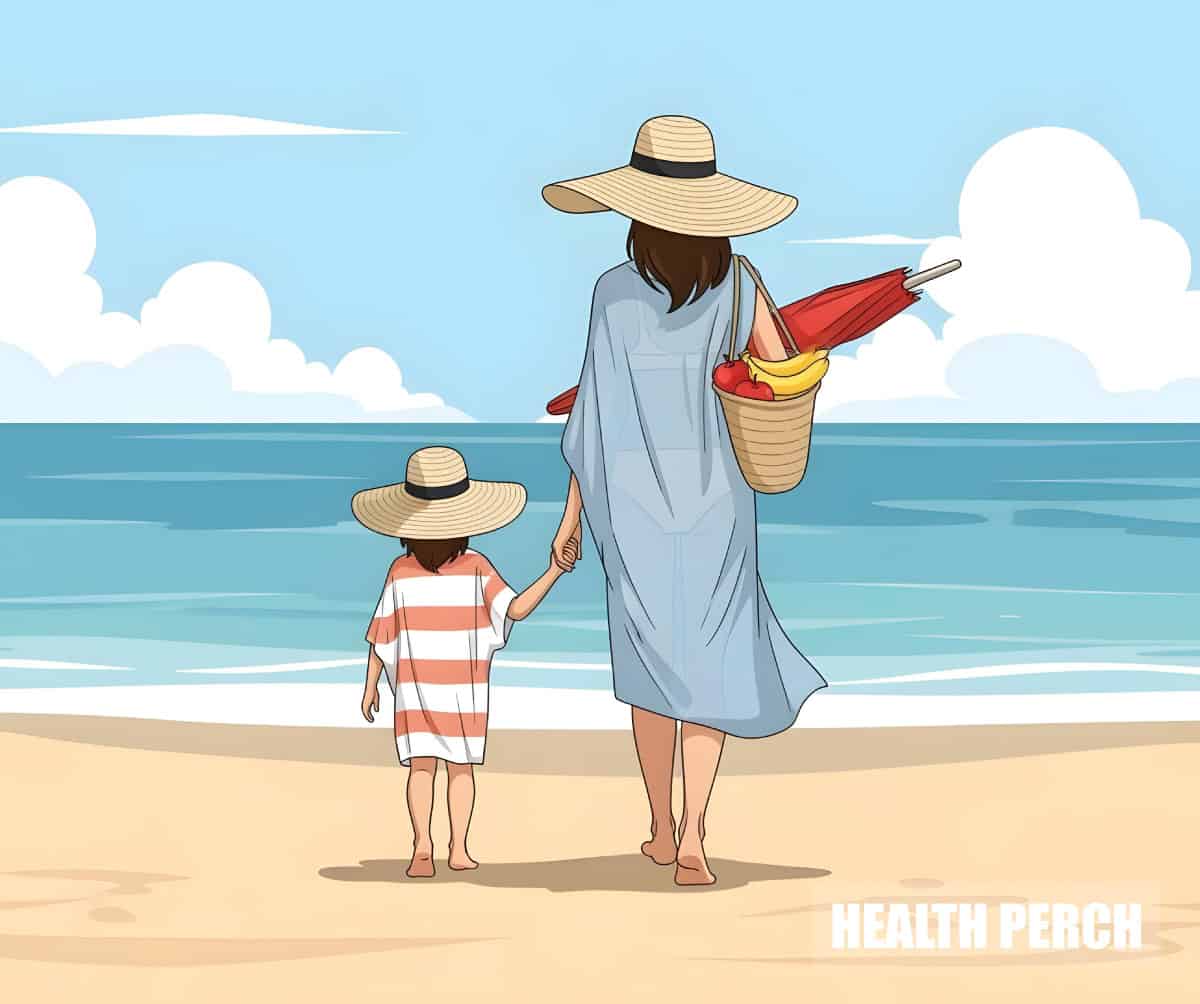 Women walking on beach with her daughter holding a fruit basket and an umbrella